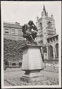 Statue of a man sitting with head in hand