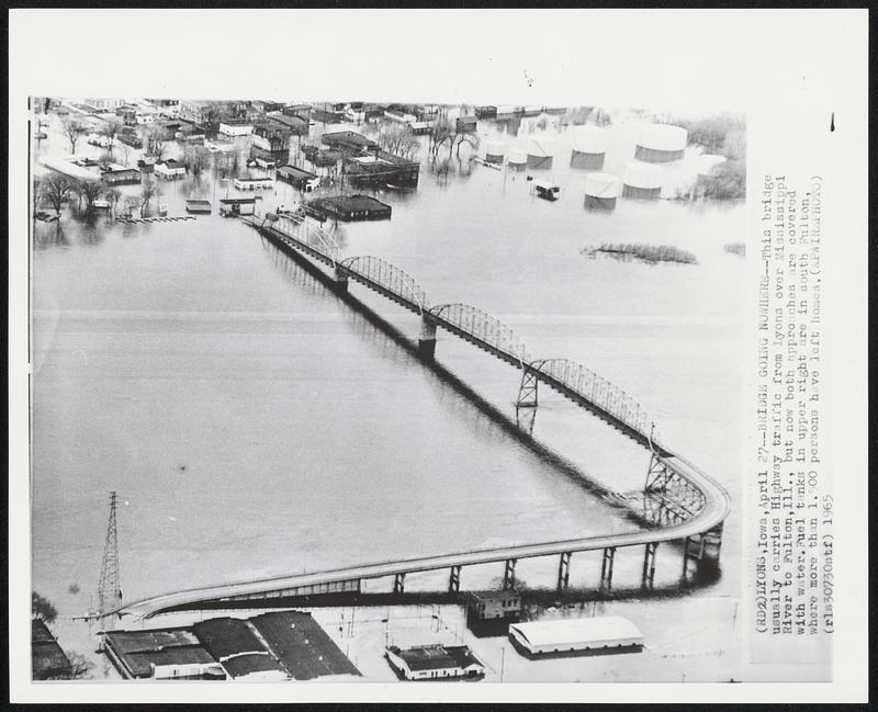 Bridge Going Nowhere--This bridge usually carries Highway traffic from Lyons over Mississippi River to Fulton, Ill., but now both approaches are covered with water. Fuel tanks is upper right are in south Fulton, where more than 1,500 persons have left homes.