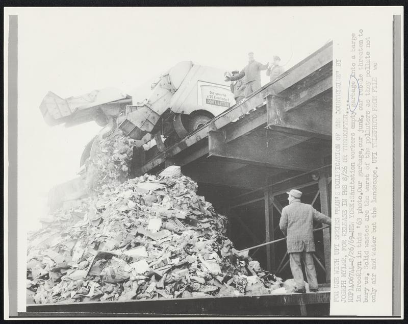 Sanitation workers empty garbage into a barge in Brooklyn in this ‘63