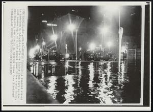 Mobile Flooded--A flooded street in downtown Mobile, Ala., reflects lights from fire equipment answering a call for downed power lines early today. The flooding was result of extreme tides from Hurricane Camille.
