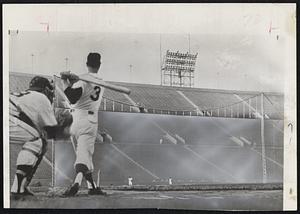 Dodgers’ Famed Fence in the Coliseum is the target for Johnny Werhas of the University of Southern California baseball team. Johnny and his teammates clouted 11 homers over the 42-foot high fence in left field during batting practice yesterday. The fence is 250 feet from the plate at the foul line.