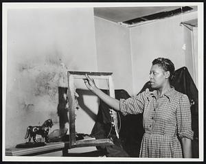 Miss Ethel Hill, 374 Columbus Ave, the Frame of a Mirror That Was Knocked From the Wall and Destroyed When Lighting Struck the Roof of Her 3rd Floor Apt. Note Hole in Roof Where the Lighting Hit. Weather - Storms Rain - 8-5-52