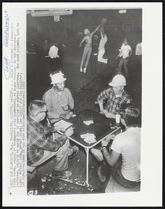 Waiting, Waiting...While a foursome in foreground plays cards, others in background play basketball at Kezar Pavilion in San Francisco yesterday, waiting to apply for 32 openings as street cleaners. The card players, left to right: Bufford Long, Arnold Adams, Lee Dahlin and Jim Sullivan.