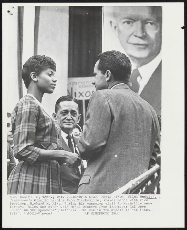 Olympic Champ Meets Nixon – Wilma Rudolph, Tennessee’s Olympic heroine from Clarksville, shakes hands with Vice President Richard M. Nixon during his campaign visit to Nashville yesterday. Wilma and other Gold Medal winners from Tennessee A&I were seated on the speakers’ platform. The man in the middle is not identified.