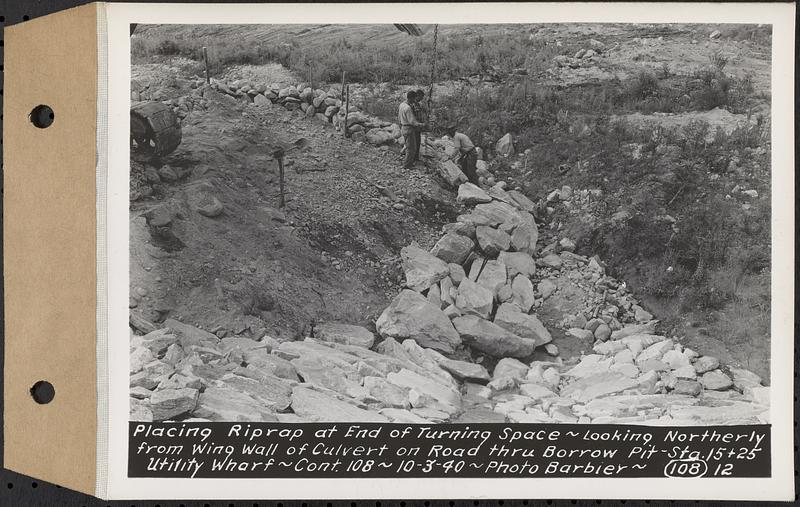 Contract No. 108, Utility Wharves, Quabbin Reservoir, Ware, placing riprap at end of turning space, looking northerly from wing wall of culvert on road through borrow pit, Sta. 15+25, Ware, Mass., Oct. 3, 1940