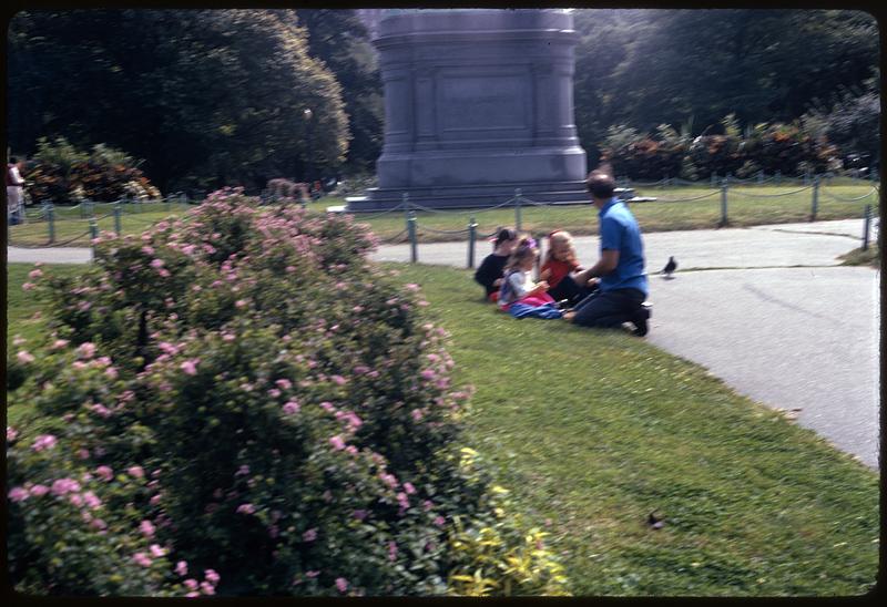 Girls sitting on grass in front of George Washington statue, Boston Public Garden