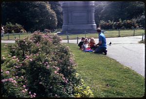 Girls sitting on grass in front of George Washington statue, Boston Public Garden