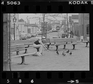 Beth Johnson on Market Square bench with pigeons