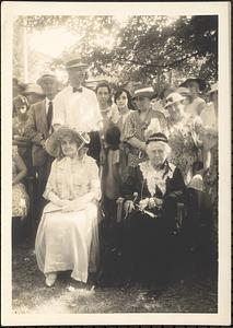 Two costumed women seated