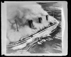 French liner SS Atlantique on fire off Guernsey, England