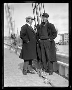 Two unidentified men on the deck of a ship