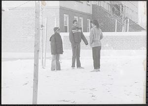 Three friends outside Washington Elms, standing in the snow