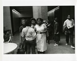 People gathered in a high school hallway