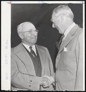 Old Friends Meet - Former President Harry S. Truman and former Secretary of State Dean Acheson shake hands warmly at Union Station, Washington, as Truman arrives to attend Democratic conferences.