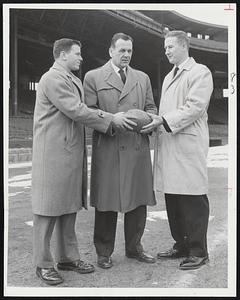 New Head Coach of football at Boston University is Steve Sinko (center). He is flanked by his 1957 co-captains, Larry Vinecour of New Rochelle, N.Y. (left), and Jack Regan of Medford. Sinko, former line coach, succeeds Buff Donelli, who replaced retired Lou Little at Columbia.