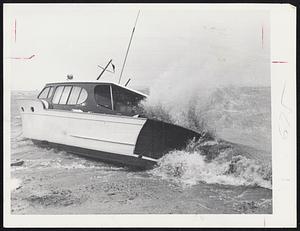 Waves smash into cabin cruiser run aground on Malibu Beach, Dorchester. Several other boats were damaged by the pounding surf and the high tide that lashed the shore in advance of Hurricane Esther's steady march northward.