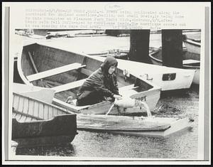 A scene being duplicated along the southeast New England coastline, bailing out small boat, is being done by this youngster at Pleasant Park Yacht Club,Winthrop,9/9,after heavy rain fell influenced by hurricane Gerda. The hurricane veered out to sea sparing the Cape Cod area.