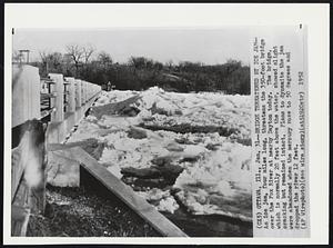 Bridge Threatened by Ice Jam-- An ice jam, four miles long, threatens the 350-foot bridge over the Fox River at nearby Dayton today. The bridge, which is normally 20 feet above the water, showed slight cracking but remained intact. Plans to dynamite the jam were abandoned when the mercury rose to 50 degrees and dropped the river 12 feet.