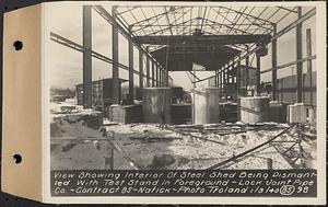 Contract No. 85, Manufacture and Delivery of Precast Concrete Steel Cylinder Pipe, Southborough, Framingham, Wayland, Natick, Weston, view showing interior of steel shed being dismantled with test stand in foreground, Natick, Mass., Jan. 3, 1940