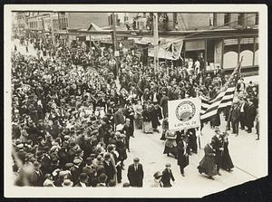 Four thousand mill strikers, two-thirds of whom were women, paraded through the streets of Passaic, N.J., as a protest against their working conditions. They carried banners telling the public of their grievances.