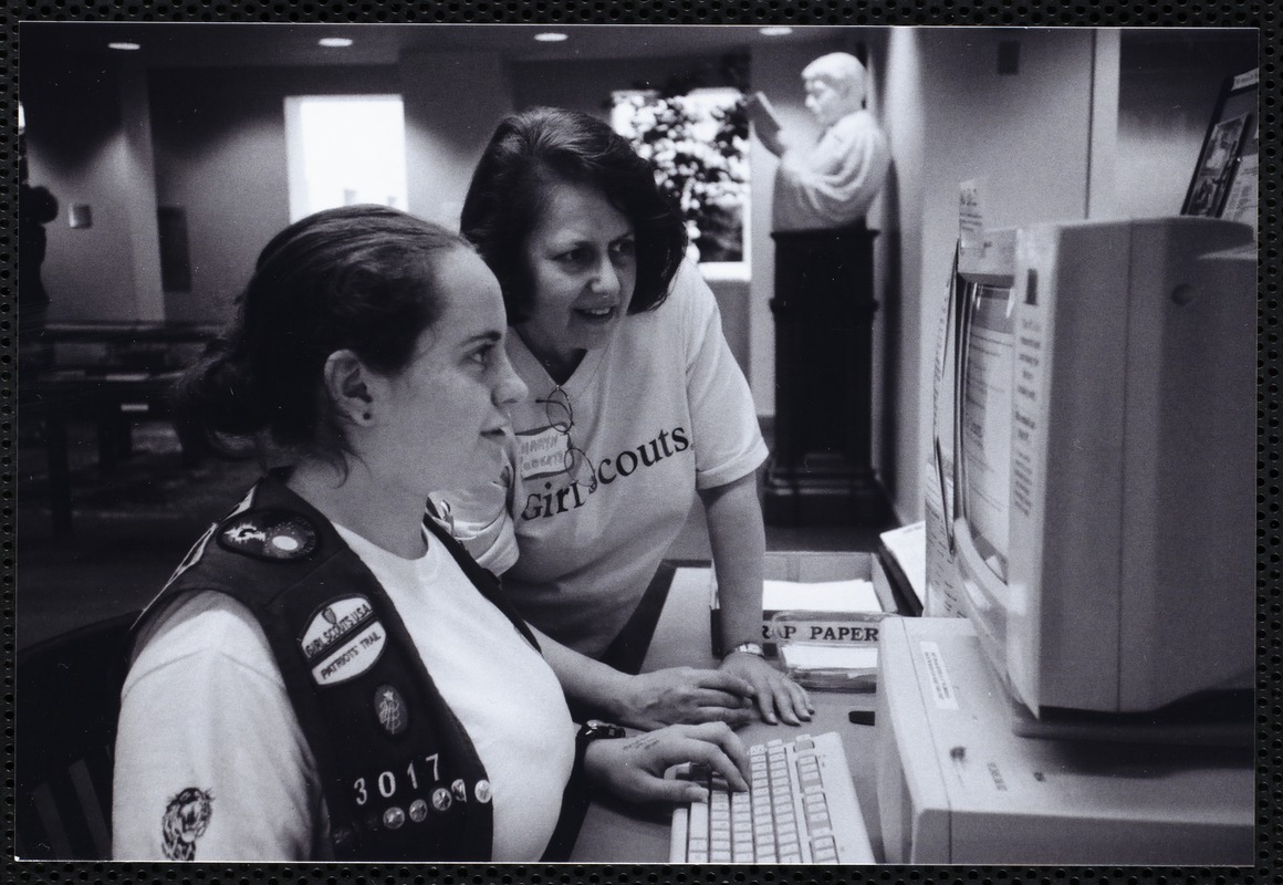 Newton Free Library, Newton, MA. Communications & Programs Office. Girl Scout, leader, at computer