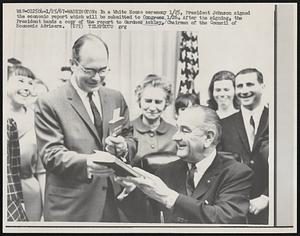 Washington: In a White House Ceremony 1/25, President Johnson signed the economic report which will be submitted to congress 1/26. After the signing, the President hands a copy of the report to Gardner Ackley, Chairman of the Council Economic Advisers.