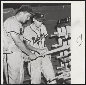 Helping Hand for Braves catcher Del Rice is provided by his son, 13-year-old Ronnie, selecting a bat for his father, who got one hit as the Braves defeated Cincinnati, 9-2, at Milwaukee.