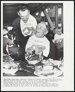 Honored Guests at Lobster Bake-New York Mets pitcher Carlton Willey supplies a bib for his boss, manager Casey Stengel.as they prepare to tackle servings of Maine lobster Monday in New York's Shea Stadium. Willey, a native of Cherryfield, Maine; Stengel and the whole Mets team were guests of the State of Maine and a Bangor newspaper at the affair.