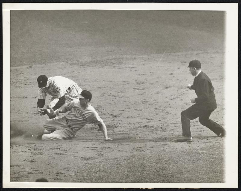 Crime doesn't pay -- Attempting to steal second base in the fourth inning, Bill Werber, fleet-footed Reds third baseman was cut down, Dickey to Crusetti, who's seen tagging the sliding runner. This bit of action took place in the second game of the World Series between the Yanks and Cincinnati Reds in New York Oct. 5 which the Bronx Bombers won 4-0. Umpire Pinelli crouches at right as he calls Werber out