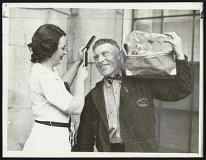 ‘Tong War’ Participant being prettied by Dorothy Regan of the Back Bay is brawny “Red” Smith, who will compete Sunday at Norumbega park for title of Boston’s handsomest iceman. The national contest will be in New Orleans during the convention of the National Association of Ice Industries.