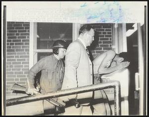 An unidentified young Negro is escorted into the emergency room of a local hospital by a shot gun carrying city policeman and a city detective after racial violence and shooting broke out for the second straight night at predominantly Negro North Carolina A & T University here. Three policemen and this civilian were wounded by gunfire. The Negro was shot in the groin.