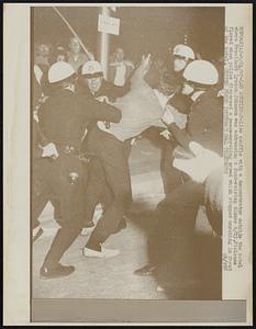 Police scuffle with a demonstrator outside the hotel where President Lyndon Johnson was addressing a fund-raising dinner 6/23. Violence flared when police dispersed a peace-marching crowd which stopped marching in front of the hotel.