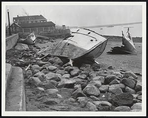 Again? -- Shattered hulks like these left by the devastating hurricane sisters Edna and Carol litter New England shores today awaiting Hazel's attentions tonight. Much of the undamaged pleasure fleet, however, already has been placed under cover.