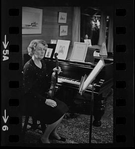 Florence Chapman Pearson seated with violin near piano