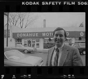 Man in front of Donahue Motor Co.