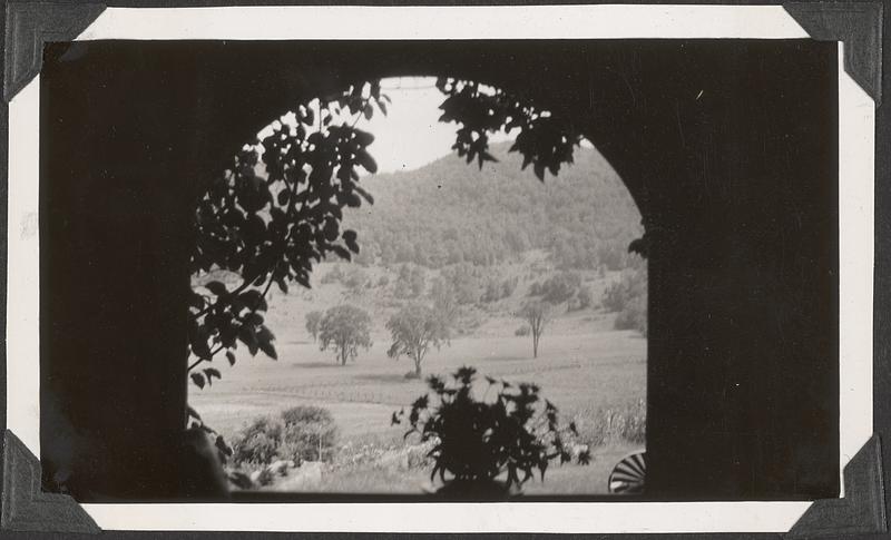 A view of a hill through an arch