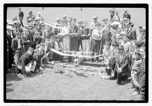 A group of boys behind a collection of model planes