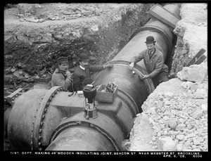Distribution Department, Low Service Pipe Lines, 48-inch pipe, making 48-inch wooden insulating joint, Beacon Street near Webster Street, Brookline, Mass., Apr. 6, 1909