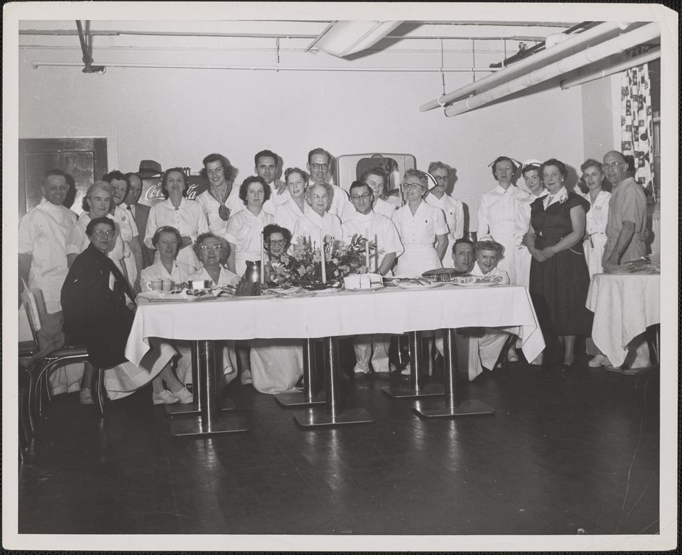 Staff at Veterans Administration Hospital behind banquet table