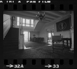 Front hall of Hammersmith Farm, the Auchincloss estate in Newport, R.I., with a framed Presidential flag