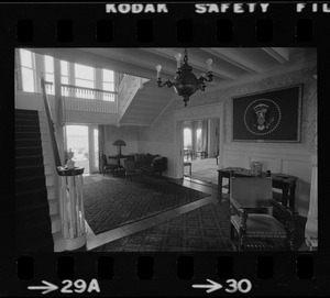 Front hall of Hammersmith Farm, the Auchincloss estate in Newport, R.I., with a framed Presidential flag