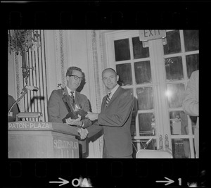 Secor D. Browne, left, chairman of the Civil Aeronautics Board, presents the Godfrey L. Cabot award to Astronaut Alan L. Bean, a member of the crew of Apollo 12, during the Aero Club of New England annual dinner held yesterday at the Sheraton Plaza Hotel