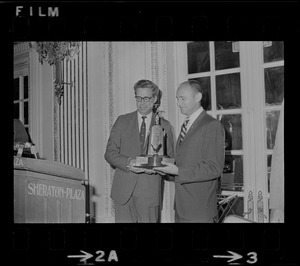 Secor D. Browne, left, chairman of the Civil Aeronautics Board, presents the Godfrey L. Cabot award to Astronaut Alan L. Bean, a member of the crew of Apollo 12, during the Aero Club of New England annual dinner held yesterday at the Sheraton Plaza Hotel