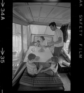 The Hinds family in a camper seated around a table