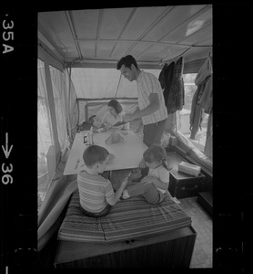 The Hinds family in a camper seated around a table