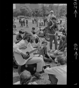 Hippie on the Boston Common playing guitar and singing