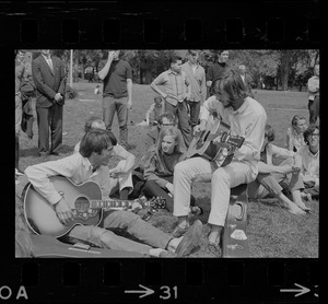 Hippies on the Boston Common playing guitar and singing
