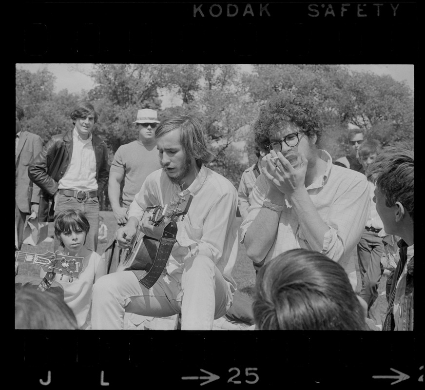 Hippies on the Boston Common playing guitar and singing