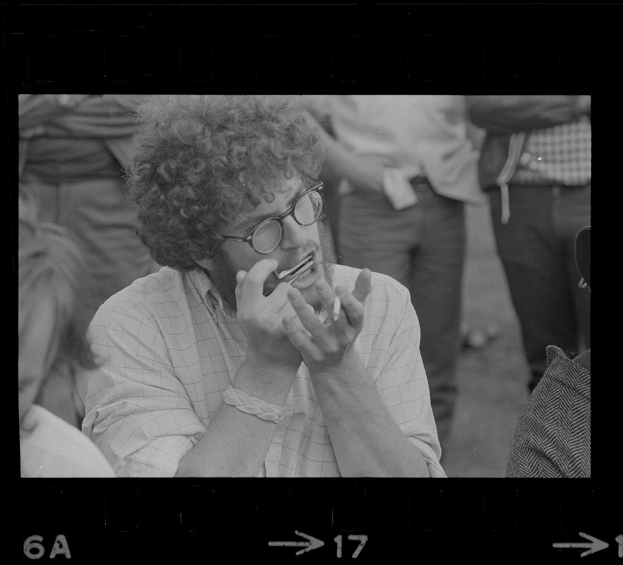 Hippie on the Boston Common playing a Jew's harp