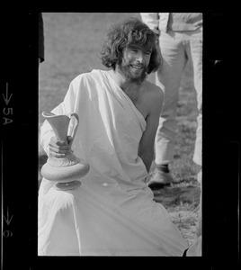 Hippie on the Boston Common dressed in a toga and holding an urn